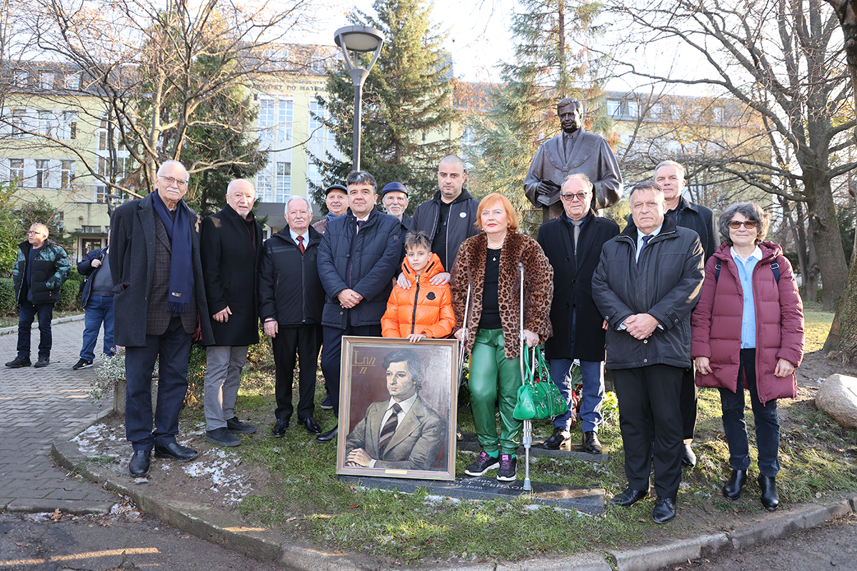 People standing in fron of new monument.